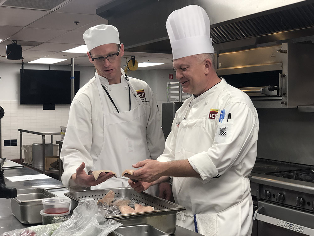 Chef Herve works with a student in a Skills Enhancement session.