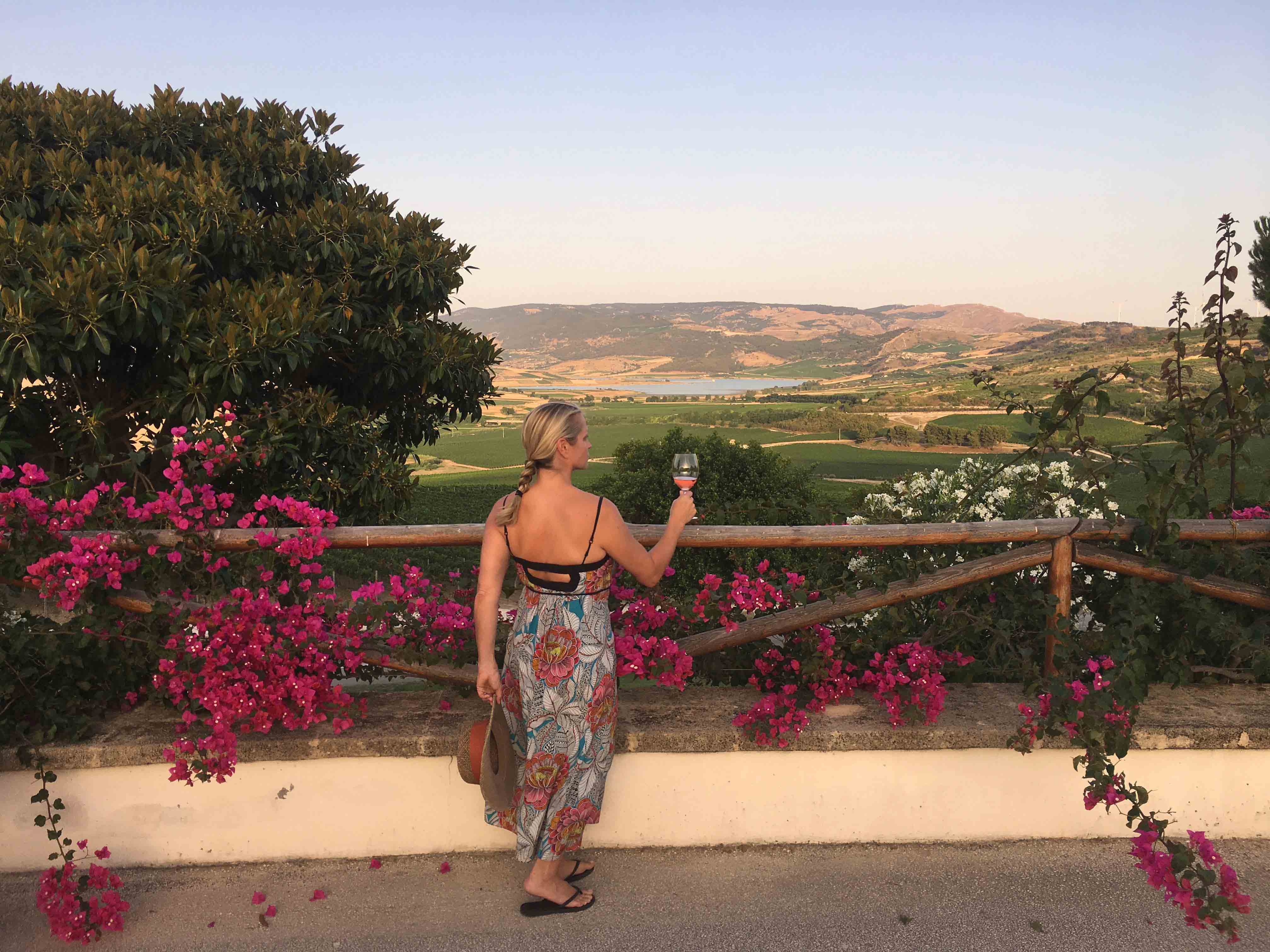 Lauren Mowery raises a glass of rose wine in Sicily.