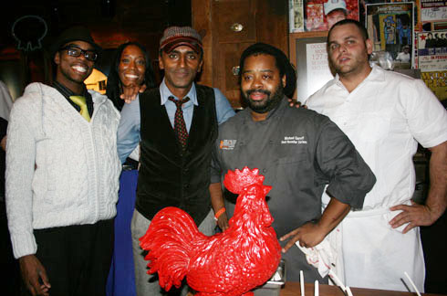 Chefs Marcus Samuelsson and Michael Garrett pose with their namesake "Red Rooster"