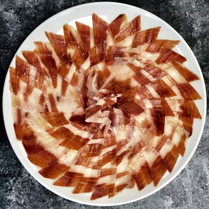 A platter of jamon iberico is served.