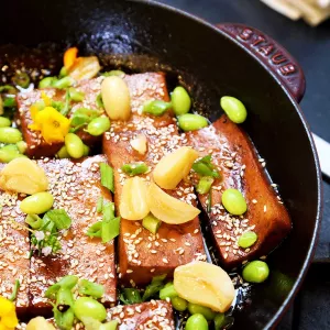 Chef Olivia's plant-based marinated tofu dish sits in a red Staub brand pan