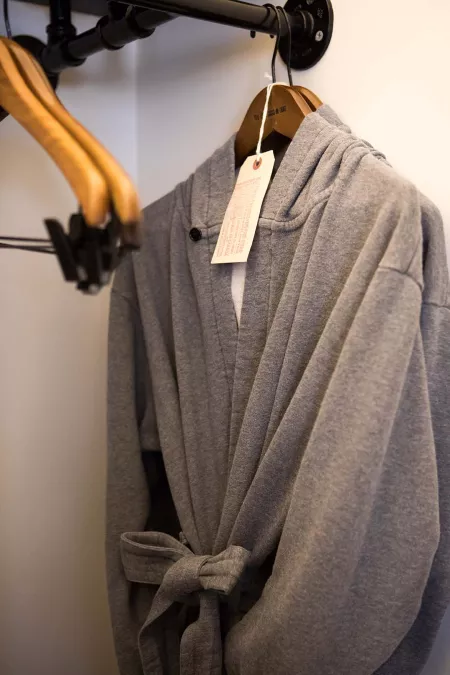 A bathrobe hangs in the closet in a hotel