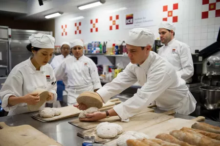 Students prepare breads for baking at the Institute of Culinary Education