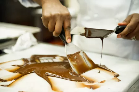 An ICE pastry student learns to temper chocolate using the traditional method