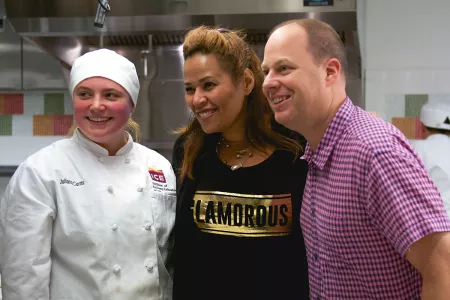 DJ Paul Cubby Bryant of Z100 and Judy Torres of KTU with a culinary student at the Institute of Culinary Education