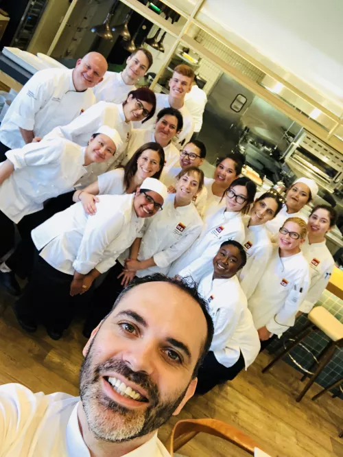 Dominique Ansel takes a selfie with ICE students on a field trip to his LA bakery.