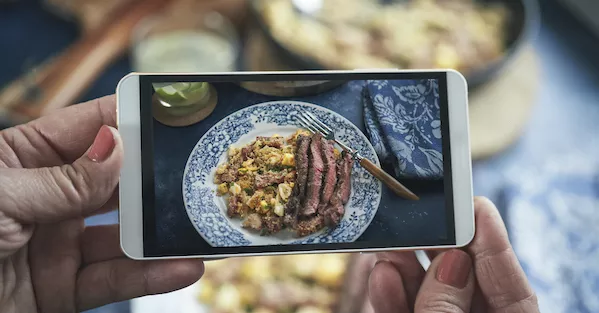 A student takes a photo of a meal for culinary school online