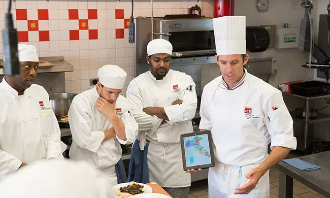 An ICE chef instructor demonstrates on an iPad at the Institute of Culinary Education