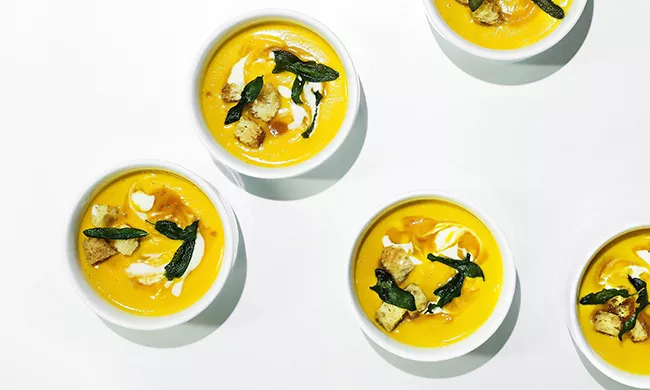 A butternut squash soup pureed in a Vitamix.