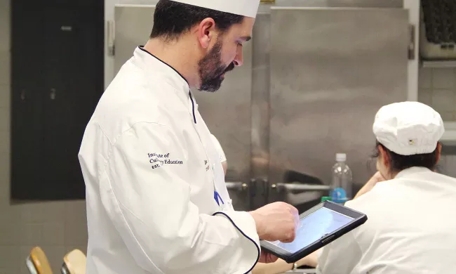 An ICE chef instructor uses an iPad at the Institute of Culinary Education