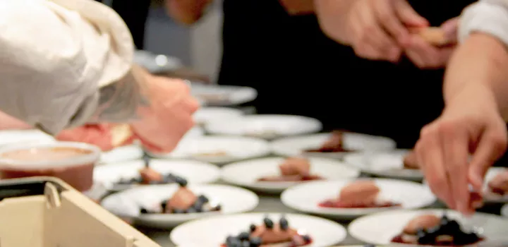 Chef Michael Laiskonis plating chocolate mousse and blueberry dessert