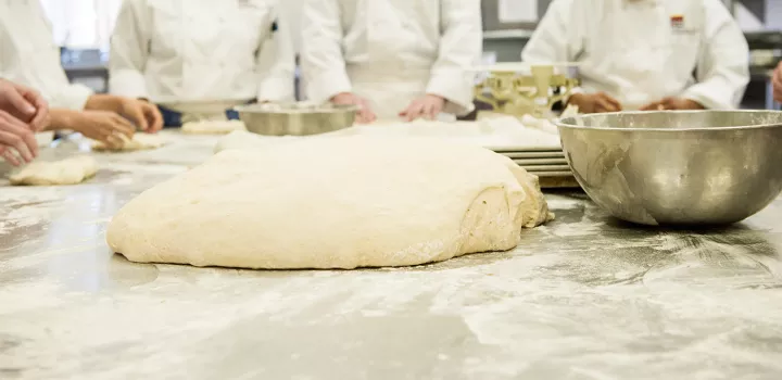 Chef Sim demonstrates how to proof, shape and score dough.