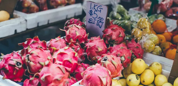 Dragon fruit is displayed at a farmers market.