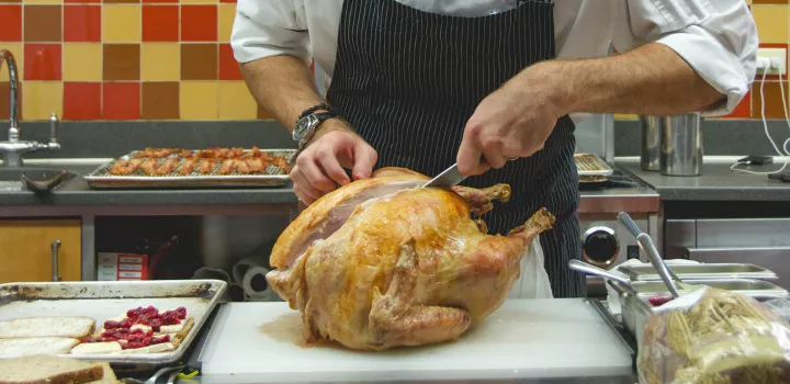A chef carves a turkey at ICE.