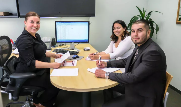 ICE financial aid advisors help a student with paperwork