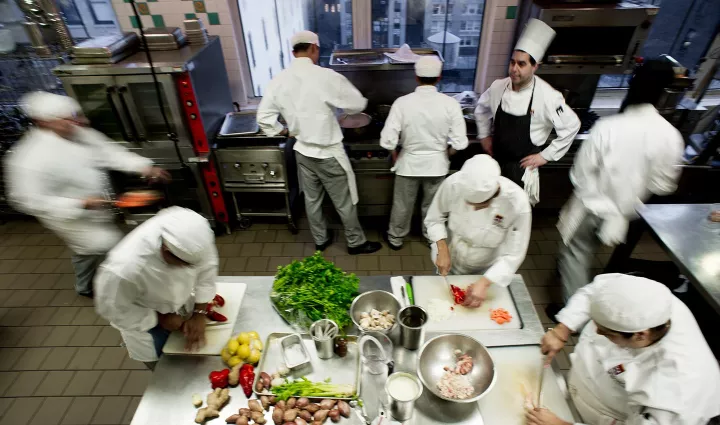 ICE culinary school students cooking in kitchens at the Institute of Culinary Education